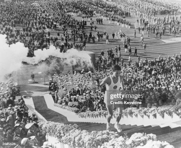 General view as Yoshinori Sakai, a student born in Hiroshima on the day the first atomic bomb devastated the city, carries the torch up the stairs to...