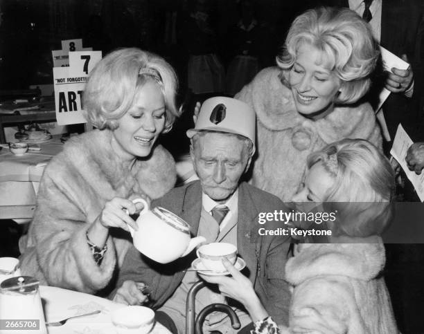 Ninety five year old Walter Reed from Queen Mary's Hospital, Roehampton has his tea poured for him by the Beverley sisters at the annual Christmas...