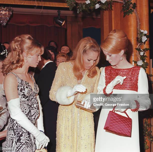 From left to right, actresses Julie Christie, Ursula Andress and Catherine Deneuve attend a Royal Film Performance of 'Born Free' at the Odeon,...