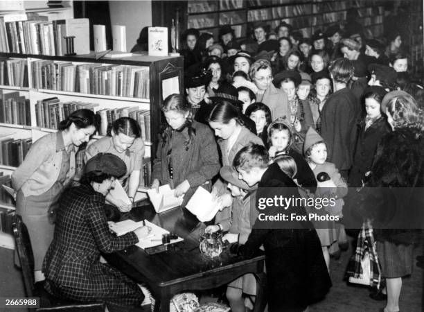 People queuing for the autograph of Enid Blyton, the English children's author, at a Brompton store.