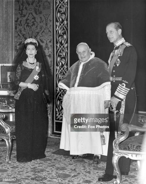 Queen Elizabeth II and Prince Philip, Duke of Edinburgh, meeting Pope John XXIII at the Vatican during an official visit to Rome.