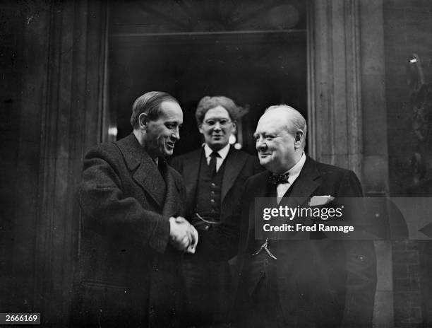 President Franklin Delano Roosevelt's special envoy Harry Lloyd Hopkins shaking hands with British Prime Minister Winston Churchill outside 10...