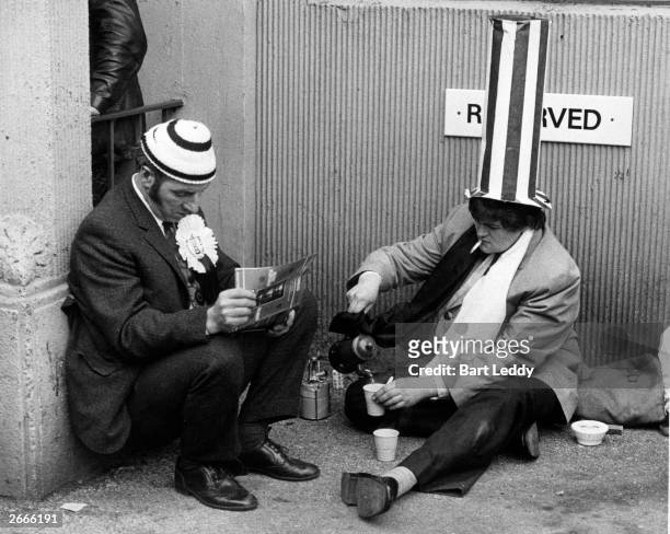 Two football fans without tickets for the match making tea on a camping stove outside Wembley Stadium, whilst the FA Cup final is played inside...