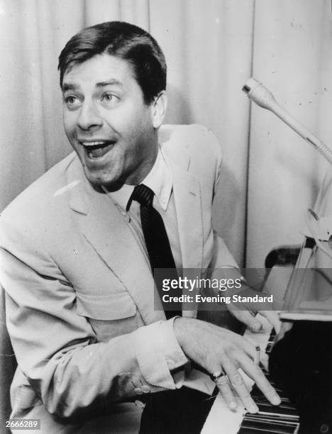 American comedy actor Jerry Lewis, with his mouth open at the piano.