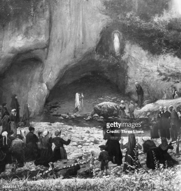 Crowds gather to watch 14-year-old Marie-Bernarde Soubirous , a poor French girl experience one of her visions of the Virgin Mary in the grotto of...