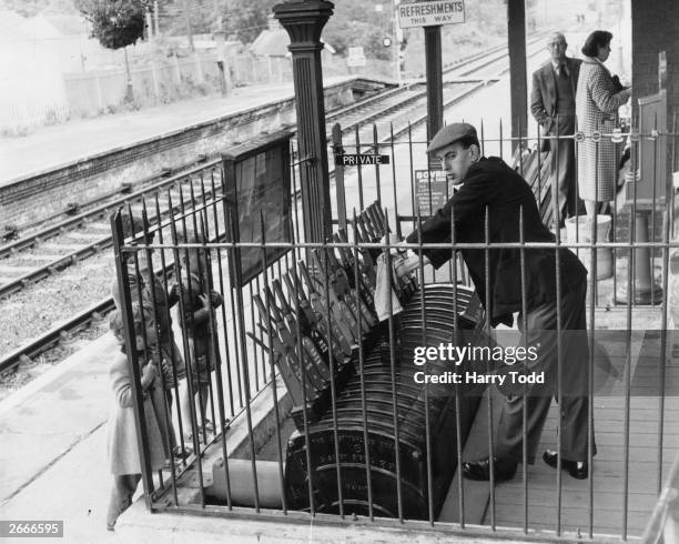 Mr D Wallis of Cheam operating signals from an open box at Sheffield Park station on the Bluebell Line. The line runs through countryside from...