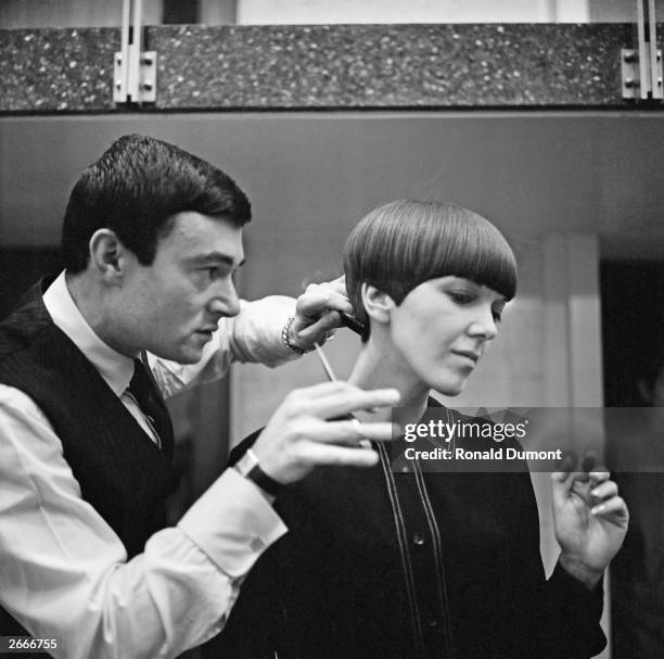 Clothes designer Mary Quant, one of the leading lights of the British fashion scene in the 1960's, having her hair cut by another fashion icon,...