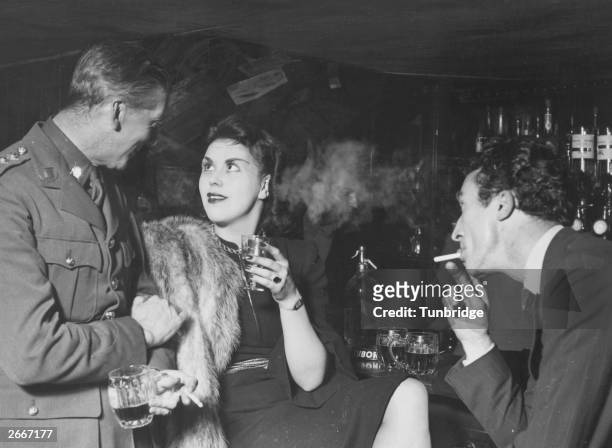 Young woman enjoys the attention of a soldier in the Pheasantry Club.