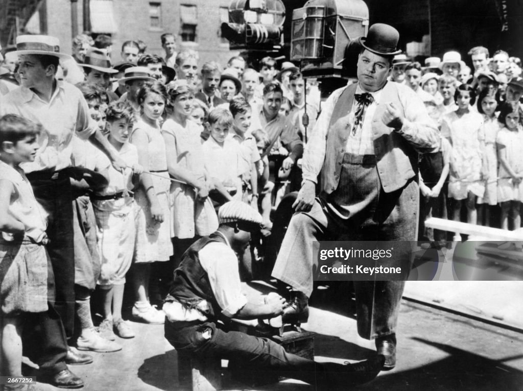 American comic actor Roscoe #39 Fatty #39 Arbuckle gets his shoes shined by American comic actor Roscoe #39 Fatty #39 Arbuckle gets his shoes shined by