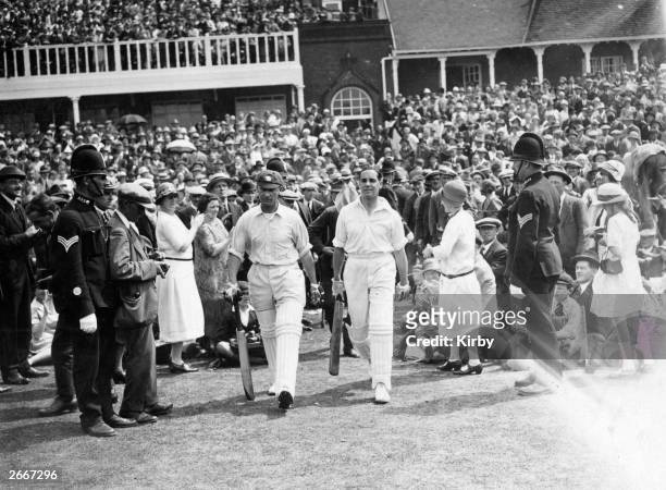 Large crowd watch opening batsmen Jack Hobbs and Herbert Sutcliffe going in to bat for England during the third Test Match against Australia at...