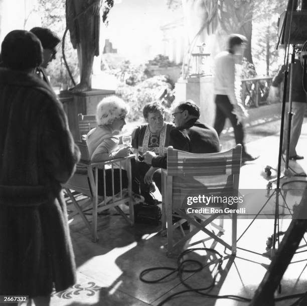 Elizabeth Taylor, Richard Burton and director Joseph L Mankiewicz on the set of the film, 'Cleopatra' produced by 20th Century Fox.