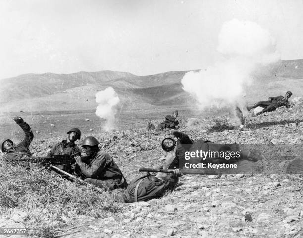 Greek soldiers practice throwing hand grenades after Greece declares war on Italy.