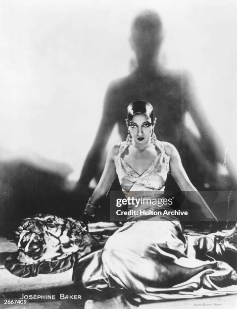 Singer and dancer Josephine Baker , sitting on a tiger rug, circa 1925.