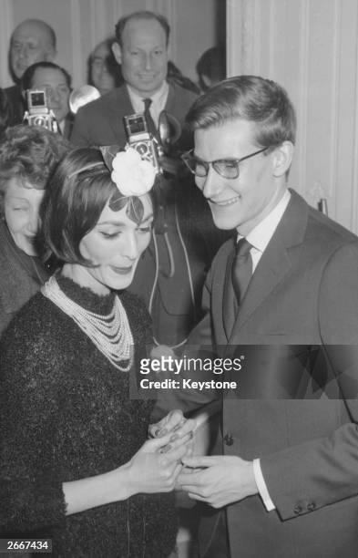 In-house designer Yves Saint-Laurent with fashion house Christian Dior's main model Kouka, at the presentation of Dior's haute couture Paris show.