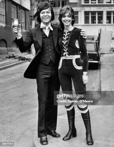 SIngers Cliff Richard and Olivia Newton John in a celebratory mood.