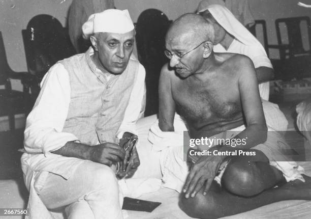 Indian statesmen Mahatma Gandhi and Jawaharlal Nehru , known as Pandit Nehru, in conversation at the All-India Congress committee meeting at Bombay.