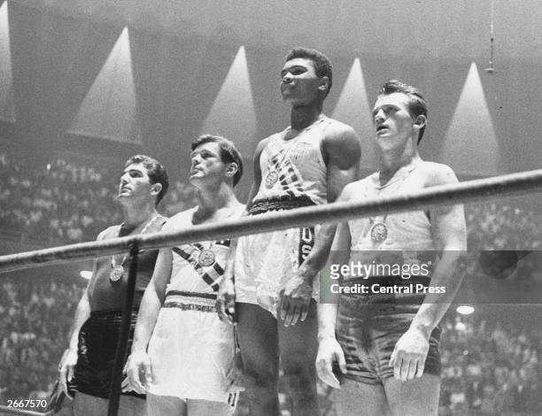 The winners of the 1960 Olympic medals for light heavyweight boxing on the winners' podium at Rome: Cassius Clay , gold; Zbigniew Pietrzykowski of...