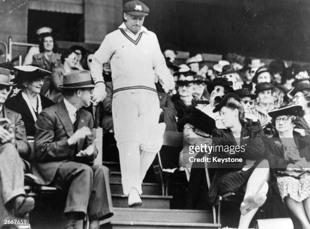 Australian cricketer Don Bradman goes out to bat.