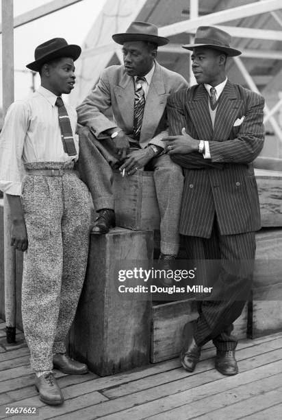 Three Jamaican immigrants John Hazel, a 21-year-old boxer, Harold Wilmot and John Richards, a 22-year-old carpenter, arriving at Tilbury on board the...