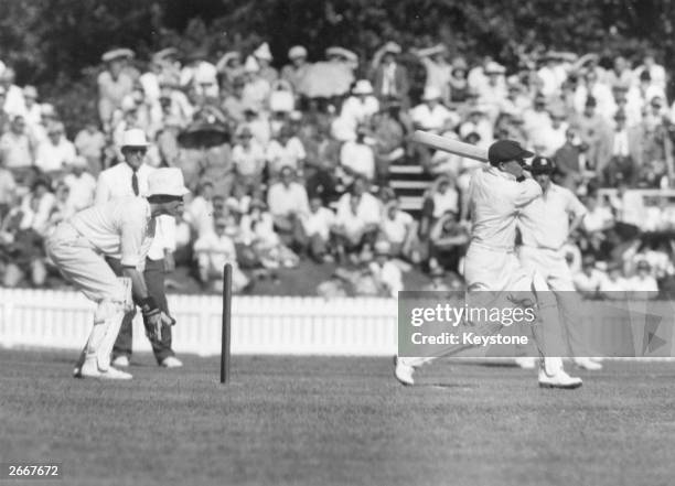 Australian cricketer Don Bradman hits the ball.