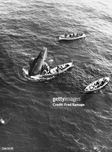 Rescue teams surround the sinking Royal Navy submarine Thetis, which encountered difficulties during testing, in the sea off Liverpool.