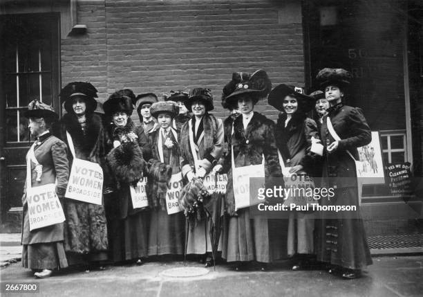 Band of 'news girls' of the Women's Suffrage Movement prepare to invade New York's Wall Street, armed with leaflets and slogans demanding votes for...