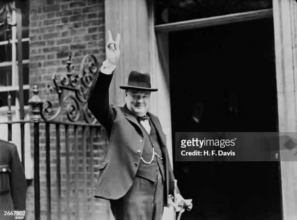 Prime Minister Winston Churchill outside 10 Downing Street, gesturing his famous 'V for Victory' hand signal, London, June 1943.