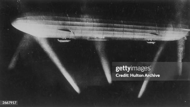 German zeppelin, caught in the searchlights during a bombing raid.