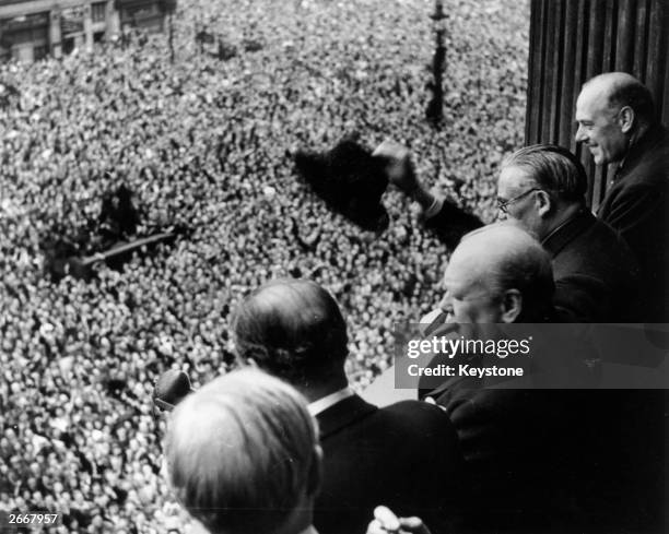 British Prime Minister Winston Churchill waving to crowds gathered in Whitehall on VE Day, 8th May 1945.