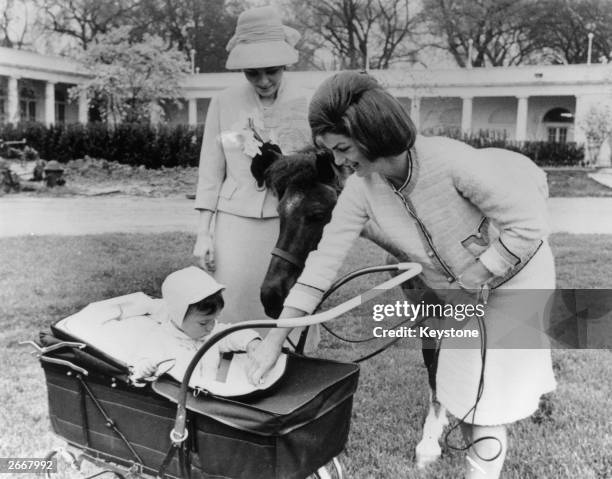 American first lady, Jackie Kennedy , introduces her son, John Kennedy Jr. To Farah, Empress Of Persia in the grounds of the White House.
