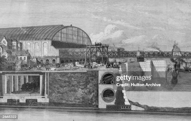 The Thames Embankment, London, under construction showing the subway , lower level of the sewer , the Metropolitan Railway and the pneumatic railway .