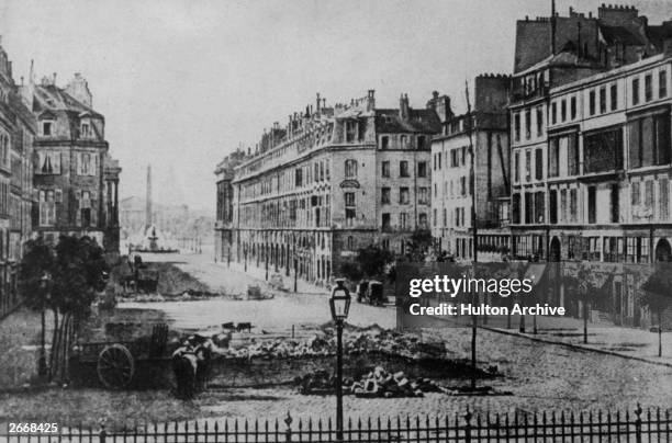 Photogravure of the remains of the barricades in the Rue Royale, Paris, near the Place de la Concorde, the Corps Legislative and the Dome des...