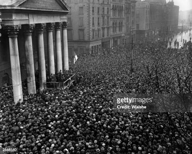 After signing the Treaty establishing the Free State, Irish politician and Sinn Fein leader Michael Collins addresses the Dublin crowd at College...