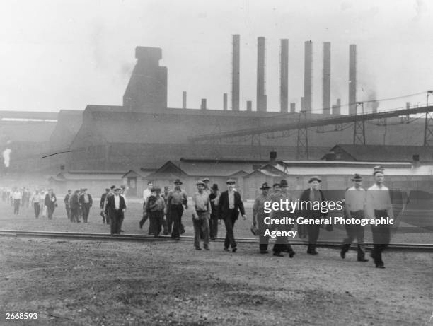 Employees of the Inland Steel Company, Indian Harbor an industrial suburb of Chicago leaving one of the mills after a day's work.