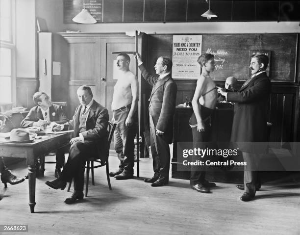 Two men conscripted to the British Army undergoing a medical check-up at Marylebone Grammar School, London.