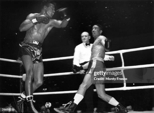 Sugar Ray Robinson's wild swing on the left misses Randolph Turpin during the World Middleweight title fight which Turpin won on points.