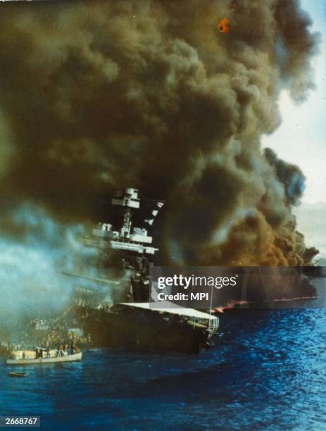 Black smoke pouring from USS California on fire in Pearl Harbour , Oahu Island after the surprise attack by the Japanese which brought America into...