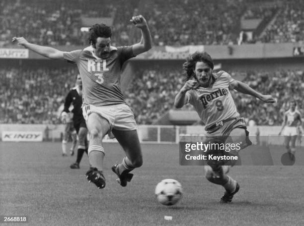Two French footballers running for the ball during the French Cup final between Auxerre and Nantes.