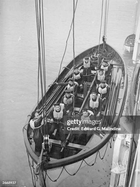 Blanche Tucker, chief cashier of the White Star liner Majestic gives the order to lower the lifeboat during a practice session. She is the first...