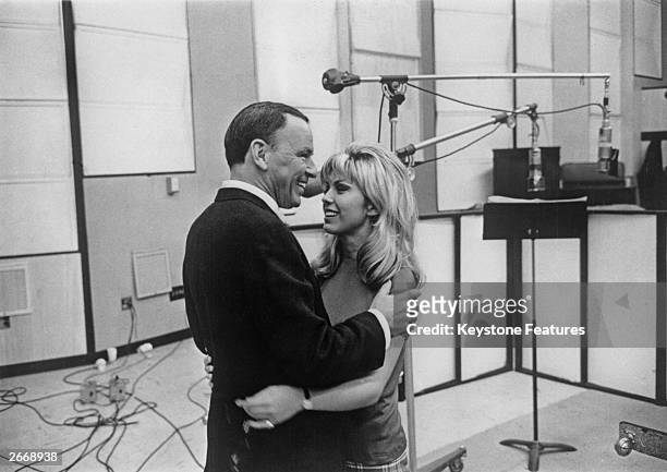 American singer and film actor Frank Sinatra with his daughter Nancy Sinatra at their first joint recording session.