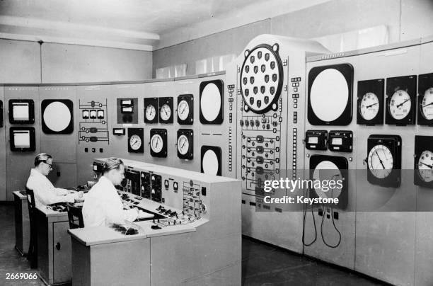 Scientists man the control desk at the Atomic Electric Station of the USSR's Academy of Sciences.