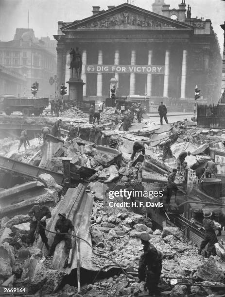 Soldiers help to clear the debris of Bank Underground Station, in front of The Royal Exchange, London, the morning after receiving a direct hit...