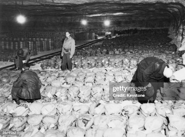 Members of General Patton's army with a stash of approximately 100 tons of gold bullion and art treasures found hidden in a salt mine near Merkers.