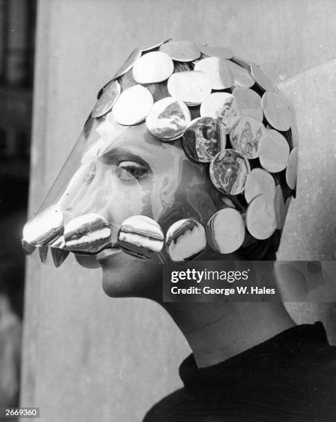 'Dollar Princess' a hat made from milk bottle tops by Reed Crawford and worn by Nikki Ross modelled at a show of autumn hats produced by the...