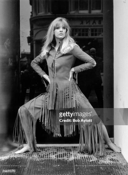 Vicki Hodge models 'Marisa', a rough suede trouser suit with long fringe, part of the Ossie Clark and Alice Pollock collection on show at the Querum...