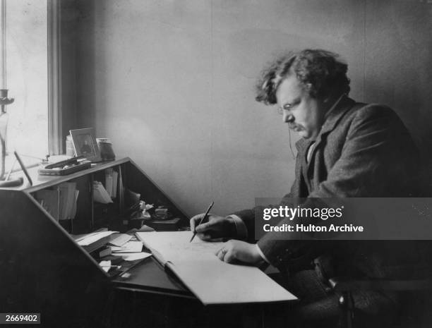 English author Gilbert Keith Chesterton at work.