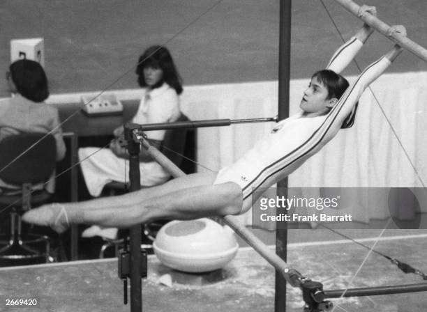 Romanian gymnast Nadia Comaneci on the asymmetric bars at the Olympic Games in Montreal.
