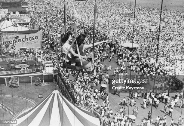 Holidaymakers on a fairground ride at Coney Island, America's popular holiday resort in Brooklyn, New York.