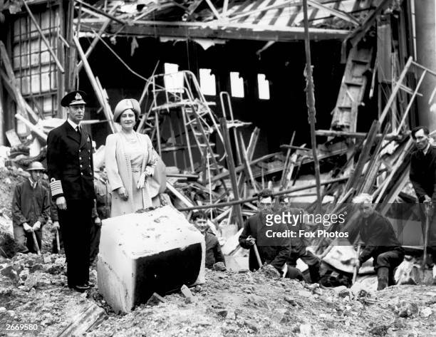 King George VI and Queen Elizabeth survey some of the damage after the bombing of Buckingham Palace, London, during the Second World War.