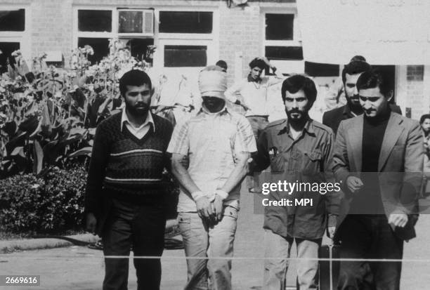 An American hostage being paraded before the cameras by his Iranian captors. Following the Iranian revolution over fifty American hostages were taken...